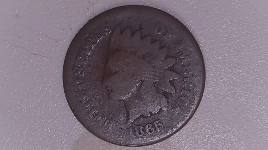A heavily worn 1865 Indian Head cent from Jen Mellen's collection, the headband, feathers and much of the legend worn down