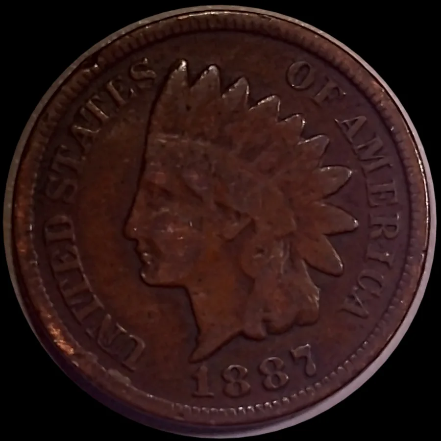 An 1887 Indian Head cent from Jen Mellen's collection, whole obverse under the microscope with the feather tips, date and denticles in focus