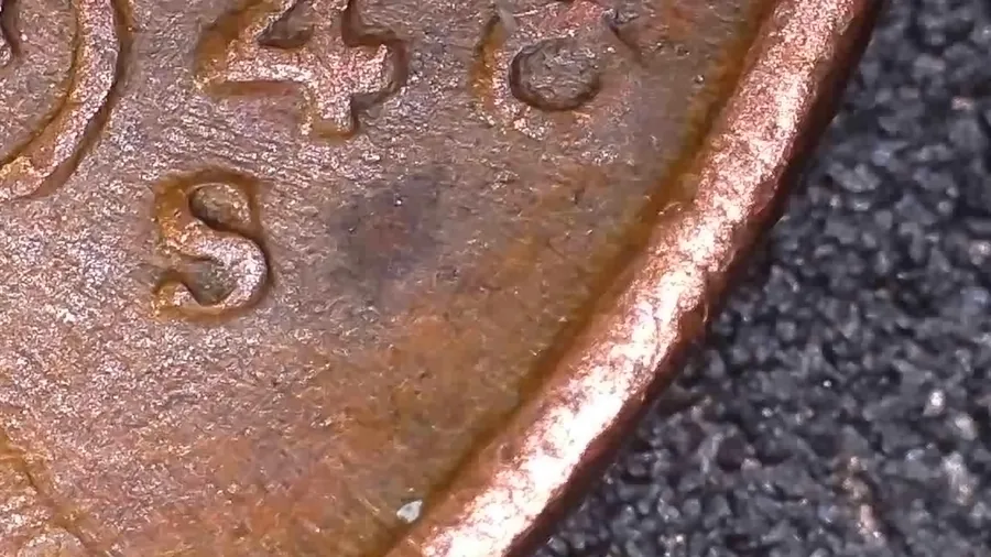 The S mint mark of a 1948-S Lincoln cent from Jen Mellen's collection, one of thirteen photographs she took of the same spot